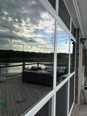 Clean windows reflecting the sky beside a Louisville patio