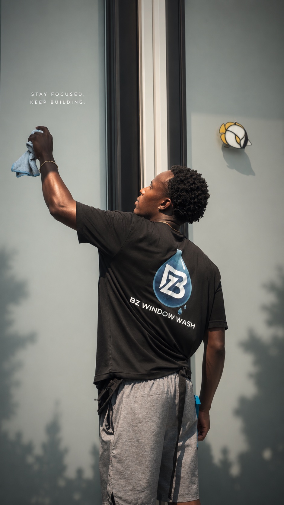 BZ Window Wash team member carefully cleaning a large window